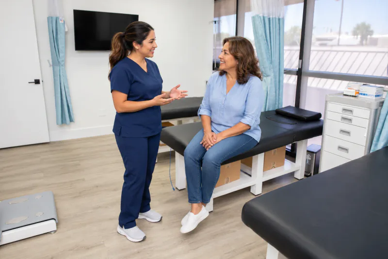 Illustrative woman and coordinator talking in an Entrust examination room