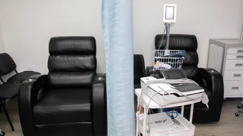Black treatment recliners, privacy curtain, and monitoring equipment at Entrust